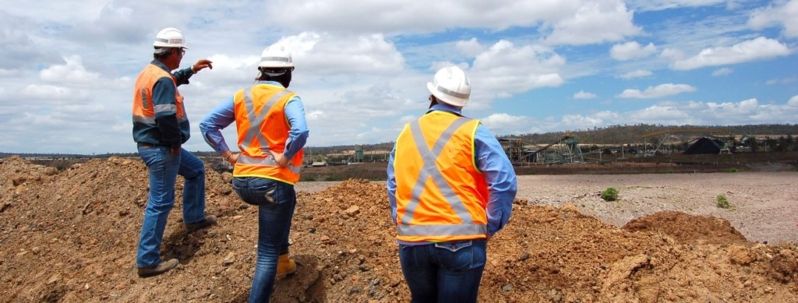 three people in high-vis observing construction
